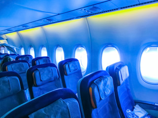 The interior of passenger airplane with the seats and screens