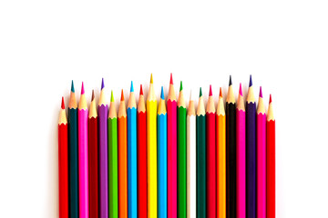 Color pencils are arranged in the form of a wavy line with a pointed side on a white background. background is isolated