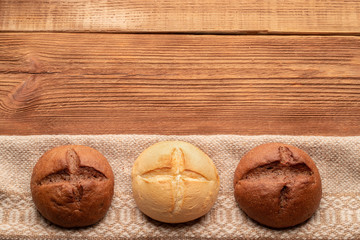 Three buns on wooden table 2