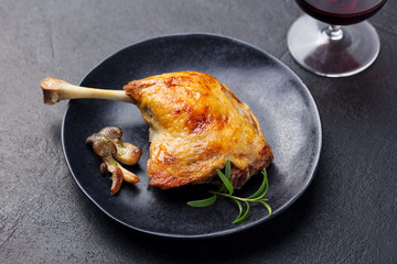 Duck legs confit with mushroom sauce . Restaurant serving. Close up.