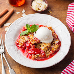 Crumble with berries and fruits with vanilla ice cream. Close up.