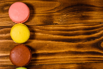 French macaroons on wooden table. Top view