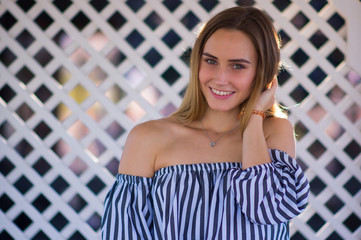 Portrait of a happy smiling girl on a light background