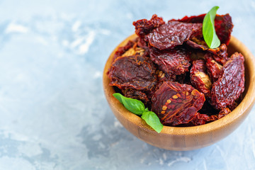 Homemade sun-dried tomatoes and basil in a bowl.