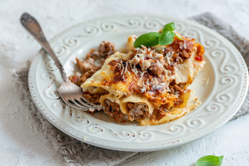 Traditional cannelloni with minced meat, tomatoes and cream sauce.