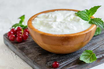 Homemade yogurt in a wooden bowl.