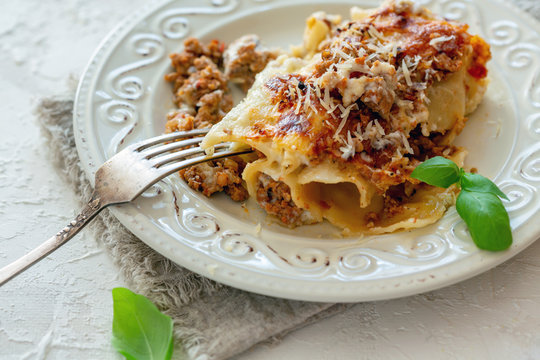 Cannelloni with minced meat, cream sauce, parmesan and fresh basil.
