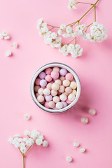 Pearl make up powder on pink pastel background. Top view.