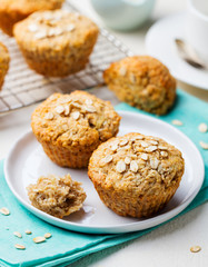 Healthy vegan oat muffins, apple and banana cakes with sour cream on a white plate. Blue background.