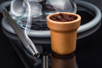 Shisha with Apple flavor in a clay bowl