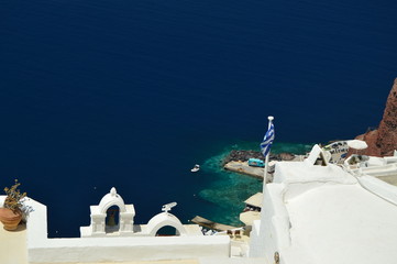 View Of Houses With Blue Vaulted Rooftop With View Of Bluish Aegean Sea In Oia Town Santorini Island. Architecture, Landscapes, Travel, Cruises. July 7, 2018. Santorini Island, Thera. Greece.