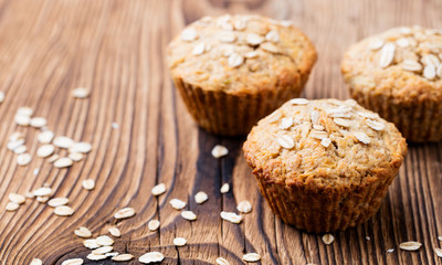 Healthy vegan oat muffins, apple and banana cakes on a wooden background. Copy space.