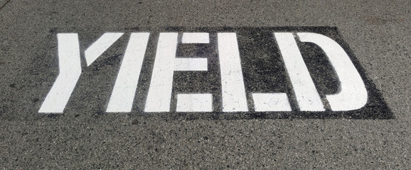 Traffic YIELD sign painted on asphalt.
