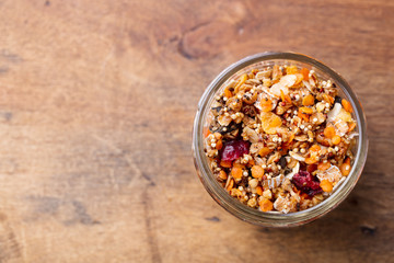 Granola, muesli in glass jar. Healthy breakfast. Copy space. Top view.
