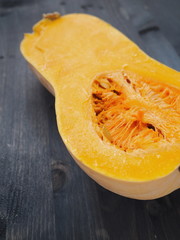 Food background with ripe butternut squash close up. Selective focus on the center. Copy space for your text.
