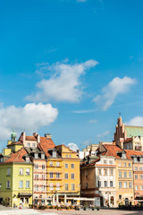 Naklejka na ściany i meble Warsaw / Poland - August 20 of 2018 : Central square with colorful houses in Warsaw city. European architecture of old town in Poland. Concept of travel and city landscape.