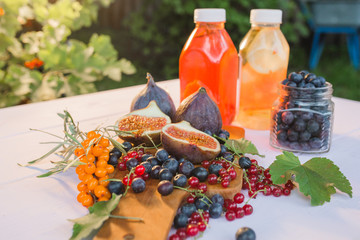 morning vegetarian Breakfast of detox water with berries and figs on a wooden Board