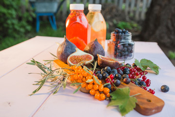 morning vegetarian Breakfast of detox water with berries and figs on a wooden Board