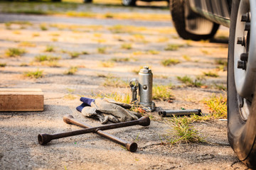 Socket wheel wrench and jack lying on ground