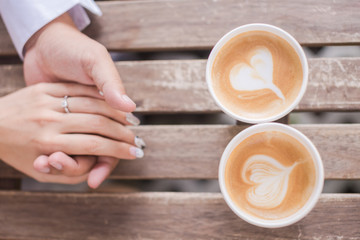 A cup of coffee in the hands of lovers