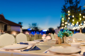 Setting the table for dining room, the table is decorated with flowers