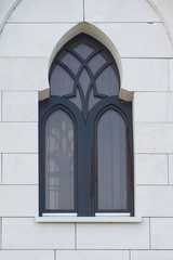 Window in a black frame on a white wall.