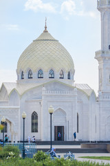 The mosque building with a beautiful yellow dome and Windows.