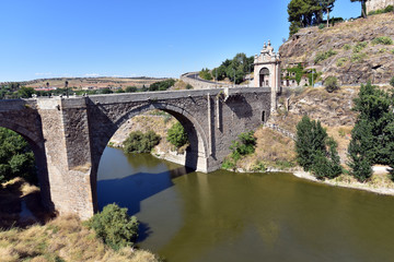 Fototapeta na wymiar Alcantara Bridge ( Puente de Alcantara ) is an arch bridge in Toledo, Spain, spanning the Tagus River