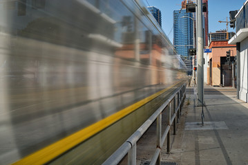 Metro train cruising down Flower street towards downtown Los Angeles.