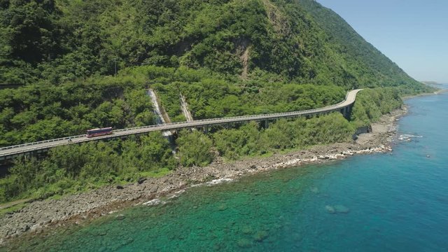 Aerial view of Patapat viaduct in the coast of Pagudpud, Ilocos Norte. Highway with bridge by coast sea near the mountains. Philippines, Luzon.