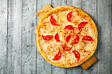 Top view tasty cheese italian pizza on wooden table