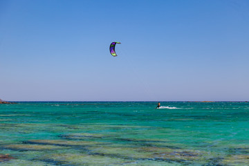Kite surfer at famous Elafonisi beach in southern Crete, Greece.