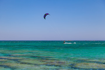 Kite surfer at famous Elafonisi beach in southern Crete, Greece.