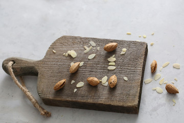 Unrefined and peeled almond on a wooden desk