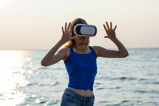 Young Woman With Virtual Reality Glasses At The Sea Background