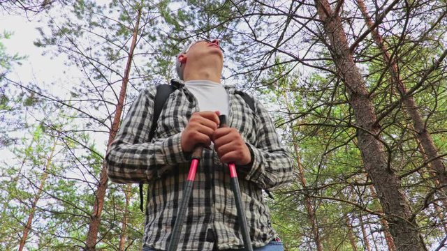 Missing in the woods , the hiker looks at the sky