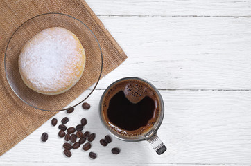 Coffee cup and donut in powdered sugar