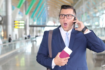 Businessman receiving bad news in the airport 