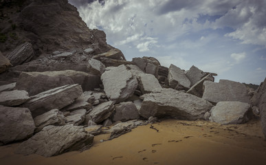 Fototapeta na wymiar Beach with rocks in summer. Playa de la Arnía in Santander, Spain