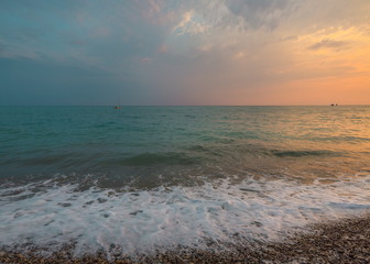 The picturesque sea at sunset. Sunset on the Black Sea with the sun. Georgia, Abkhazia. Colorful sunset with waves.