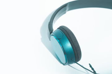 Green headphones on white background