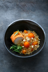 Baked turkey with bulgur, pumpkin, raisins and orange, copy space.
