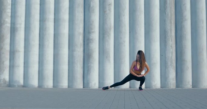 GIMBAL Fit young woman doing stretching workout. Fitness model exercising in morning outdoors. Healthy lifestyle concept. 4K UHD