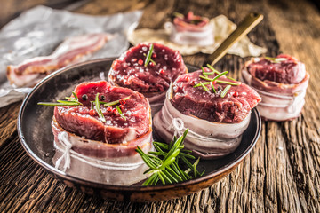 Beef tenderloin steak wrapped in bacon stored into the pan