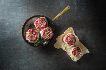Beef tenderloin steak wrapped in bacon stored into the pan