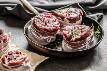 Beef tenderloin steak wrapped in bacon stored into the pan