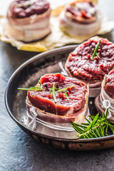 Beef tenderloin steak wrapped in bacon stored into the pan
