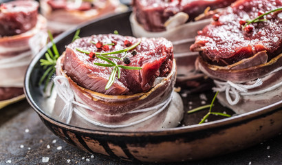 Beef tenderloin steak wrapped in bacon stored into the pan
