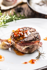 Grilled beef tenderloin steak with chili sauce in white plate