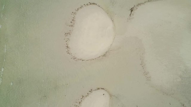 Tropical island with white sandy beach. Aerial view of Tondol White Sand Beach with colorful reef. Seascape, ocean and beautiful beach. Philippines, Anda, Pangasinan. Travel concept.